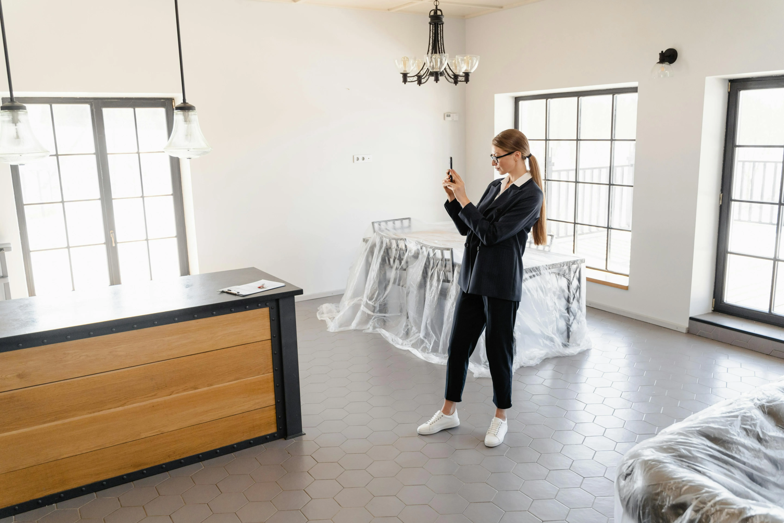 Estate agent taking property photos as part of house sale marketing.