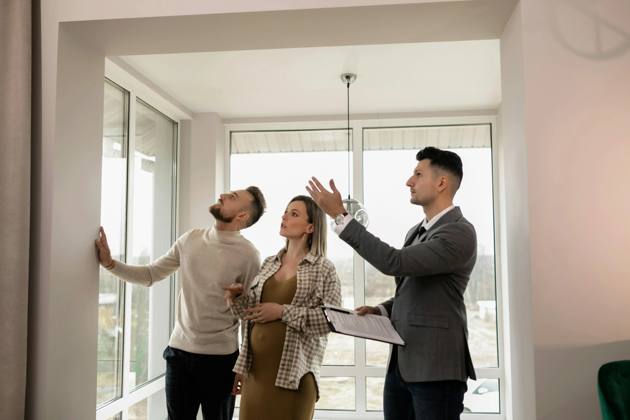 Estate agent showing clients around a property during a viewing.