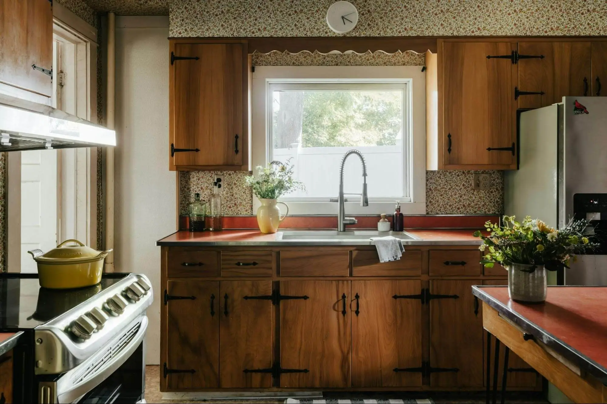 Dated kitchen with dark wood cabinets and red laminate worktops awaiting renovation