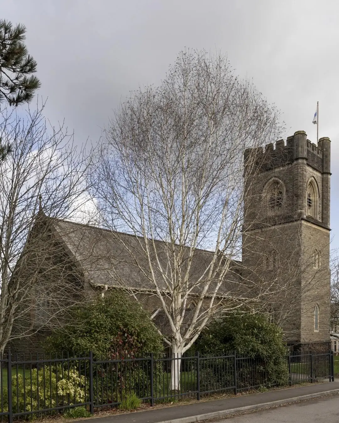 Stone church surrounded by mature trees in Radyr, Cardiff