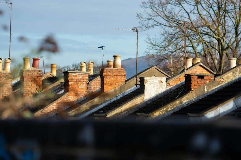 Traditional UK rooftops and brick chimneys showing residential building fabric