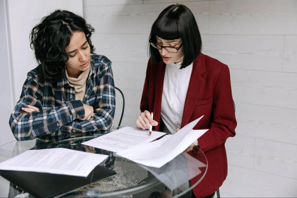 going through a tenancy agreement with a client at a desk